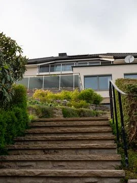 Modern house with an old stone staircase and a garden that was built in a d.. 写真素材