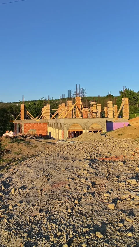 Modern house under construction captured in the warm glow of sunset Stock Footage 334678876