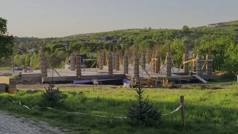 Modern house under construction captured in the warm glow of sunset Stock Footage 334840525