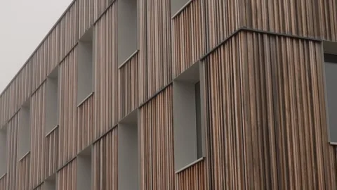 Modern housing development building exterior vertical larch wood lamella facade Stock Footage 332409165