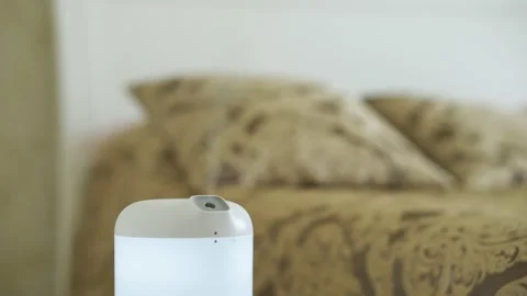 Modern humidifier, aroma oil diffuser at home interior. Comfort in the bedroom Stock Footage 204129051