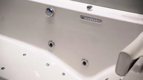 Modern hydromassage white jacuzzi tub with button control dial empty,  Pan Stock Footage 157447315