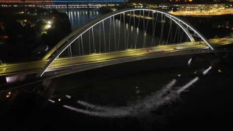 Modern illuminated bridge over river with reflections, drone night shot. Edmonto Stock Footage 316177997