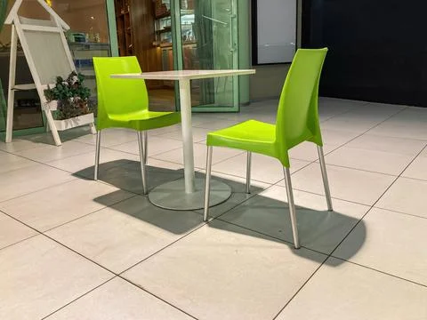 Modern indoor setting possibly cafe or restaurant, two vibrant yellow chair.. 스톡 사진