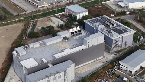 Modern industrial data center featuring a rooftop helipad, solar panels, and Stock Footage 332457357