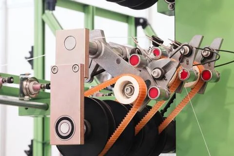Modern industrial sewing machine in operation. Threads feed through precise m Stock Photos