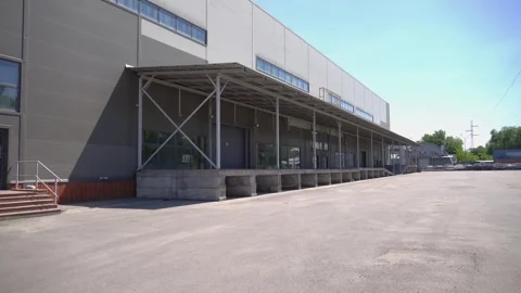 Modern Industrial Warehouse Exterior with Loading Docks Stock Footage 343175682