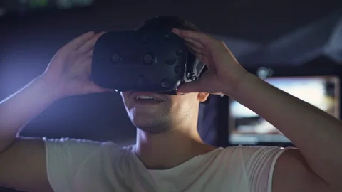 Modern interactive technologies, man puts on virtual reality glasses, exploring Stock Footage 118641102