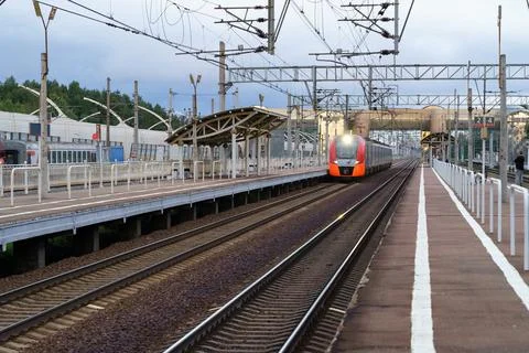 Modern intercity high speed train at sunset. Commercial suburban railroad Stock Photos
