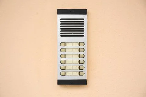 Modern intercom on beige wall. Security system Stock Photos