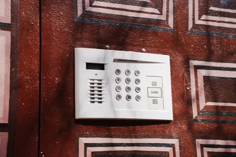 Modern intercom keypad on residential building entrance wall Stock Photos