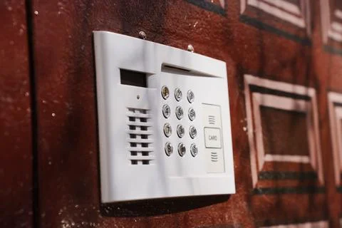 Modern intercom keypad on residential building entrance wall Stock Photos