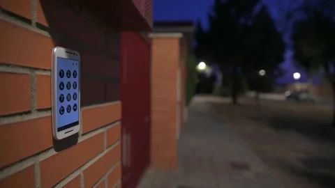 Modern Intercom With Numeric Keypad Against Brick Wall in Evening Setting Stock Footage 314258653