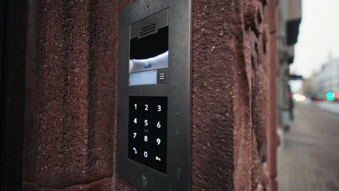 A Modern Intercom System installed at the main entrance of an Urban Apartment Stock Footage 299475273