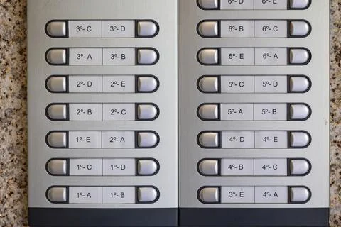 Modern intercom system showing apartment numbers and letters for buzzing re.. Stock Photos