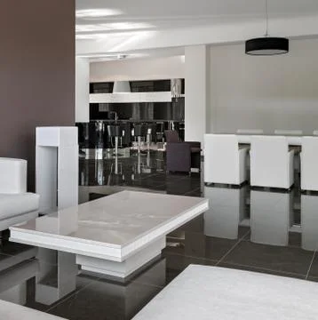 Modern interior with big table, chairs and living room in daylight Stock Photos