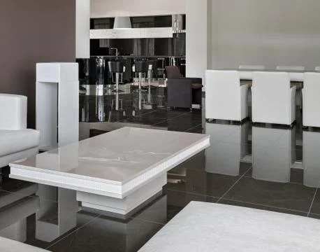 Modern interior with big table, chairs and living room in daylight Stock Photos