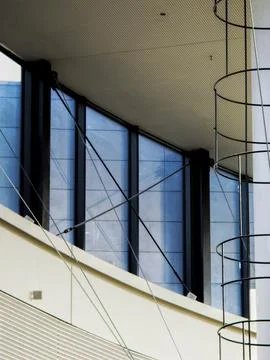 Modern interior with blue windows and circular ladder Stock Photos