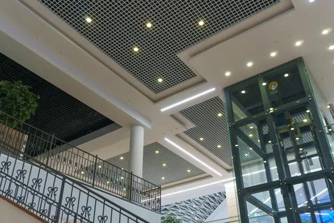 Modern interior design inside the mall. Glass transparent elevator in the bus Stock Photos