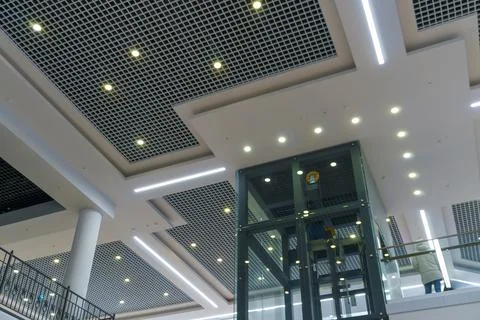 Modern interior design inside the mall. Glass transparent elevator in the bus Stock Photos