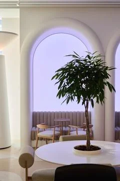 Modern interior design with a tree in a cozy lounge space Foto stock