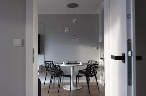 Modern Interior with Dining Area and Pendant Lighting Stock Photos