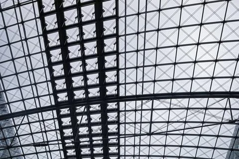 Modern interior inside a railway station with a glass roof Stock Photos