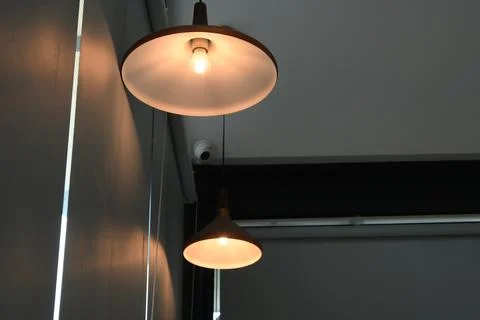 Modern interior lighting design featuring two pendant lamps suspended from .. Stock-Fotos