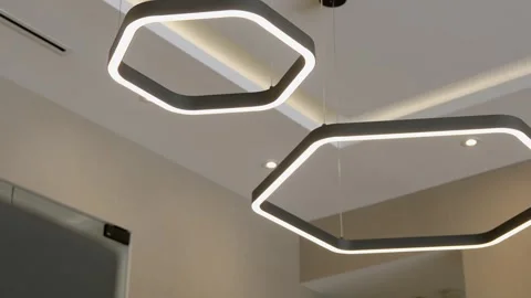 Modern interior lighting fixture with geometric design. Two interconnected Stock Footage 283383171