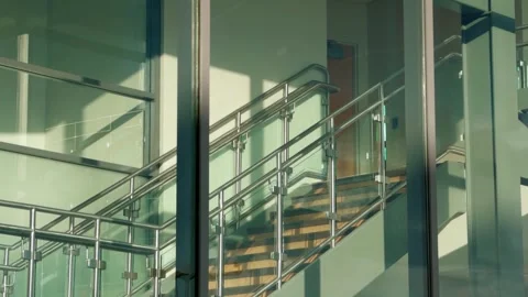 Modern Interior Staircase with Slow Diagonal Upward Pan Through Glass Stock Footage 342154160