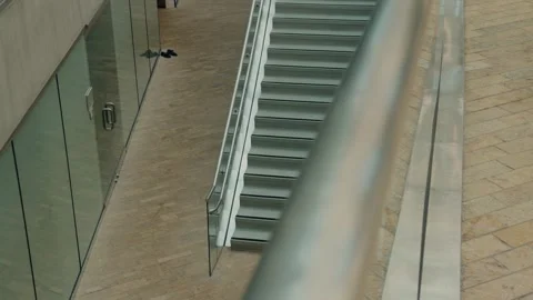 Modern Interior Staircase with Slow Left-to-Right Glide Past Glass Handrail Stock Footage 342154137