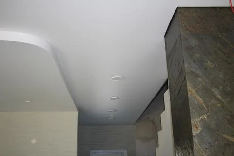 Modern interior with stretch curved ceiling and built-in led panel lighting Stock Photos