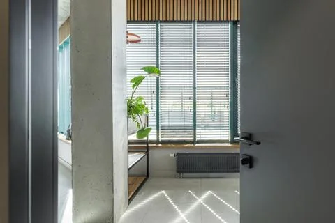 Modern Interior View through Open Door with Industrial Elements Foto stock