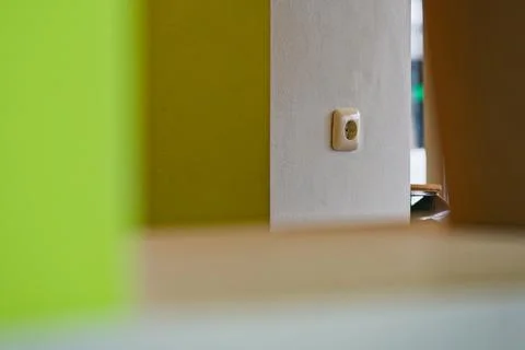 Modern interior wall with electrical outlet and vibrant green and white color Stock Photos