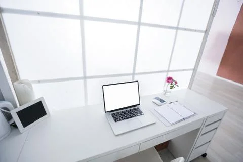 Modern interior workplace with laptop in white colors Stock Photos