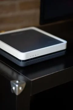 Modern internet router or modem device on a dark table Stock-Fotos