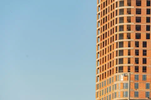 Modern, irregularly shaped windows, balconies, earth tones, overcast sky, d.. Stock Photos