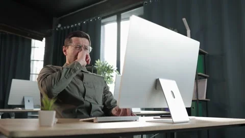 Modern IT developer or office worker yawning while typing on pc desktop. bore Stock Footage 237185937