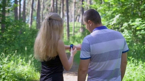 Modern jogging in the forest. Couple running. Woman setting timer Stock Footage 78036308