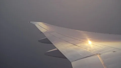 Modern Jumbojet Passenger Airplane Wing, Boeing 777 Flying, Takeoff Sunset Stock Footage 90941092