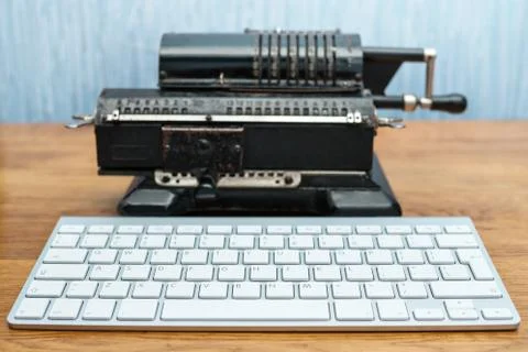 Modern keyboard and old adding machine Stock Photos
