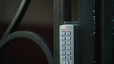 Modern Keypad Access Control Systems on gates offer secure entry, ensuring Stock Footage 307933237
