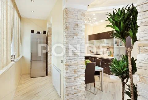 Modern kitchen and balcony interior in warm tones wide angle view Stock Photos