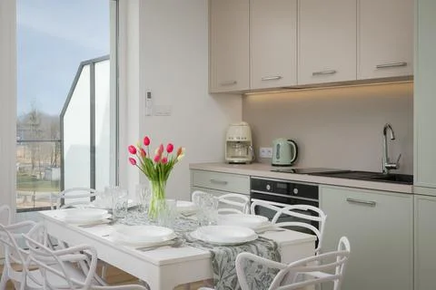 Modern Kitchen and Dining Area with Tulips Stock Photos