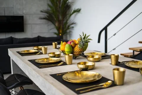 Modern kitchen with appliances. Subtle lighting. dining table made of polishe Stock Photos
