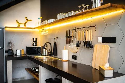 Modern kitchen with appliances. Subtle lighting Stock Photos