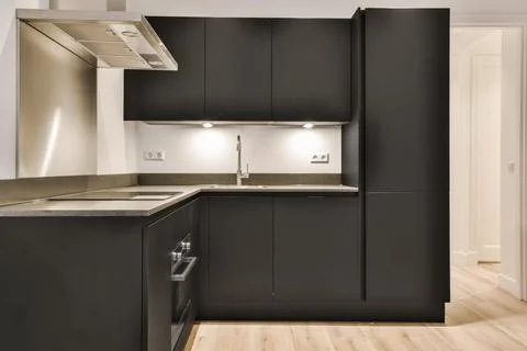 Modern kitchen with black kitchen unit Stock Photos