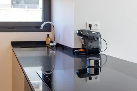 Modern kitchen with coffee machine and pop-up power socket Stock Photos