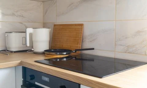 Modern kitchen corner with kettle and pan. Daily rituals, balance between f.. Stock Photos