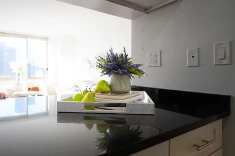 Modern kitchen counter with fruit and flowers. Фото